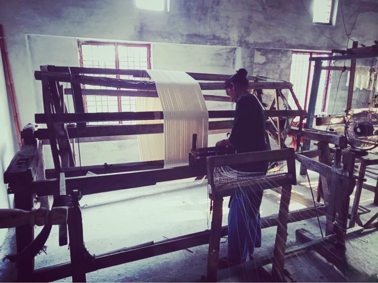 Artisan working at a handloom, crafting fine Indian textile