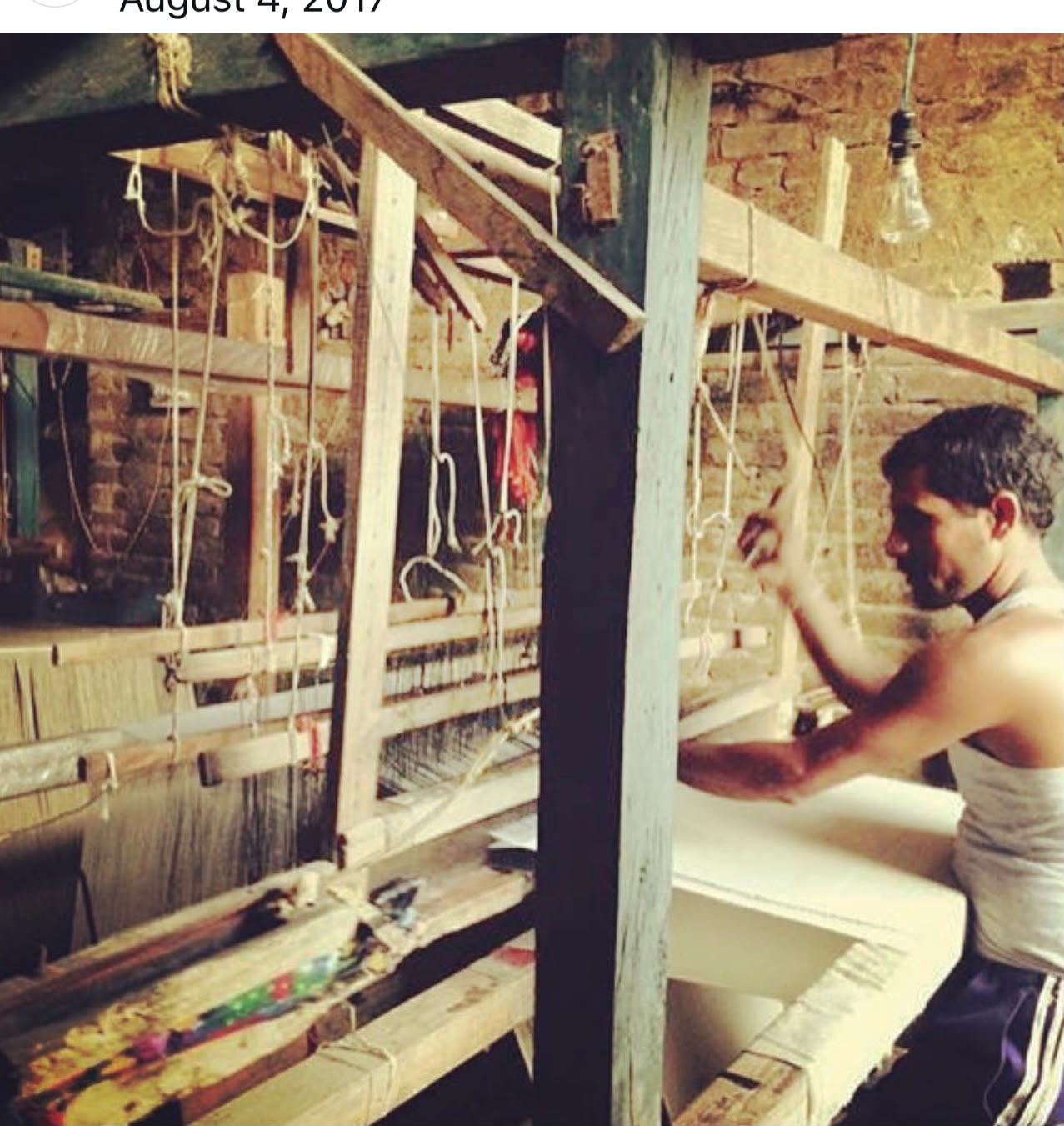 Artisan weaving fine textile on a traditional handloom