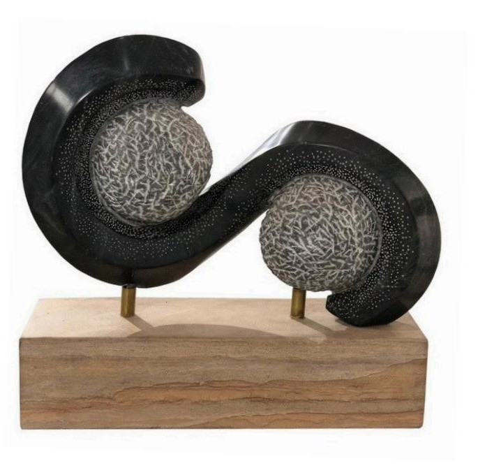 A sculptural marble objet on a carved wooden base, presented as a curated luxury gift